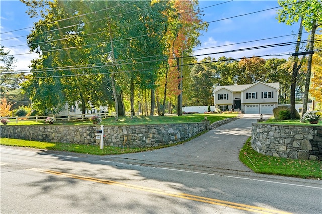 view of front of house with a front yard and a garage