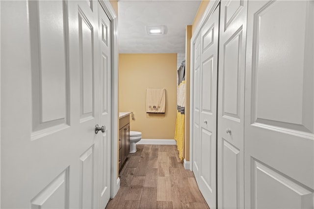 corridor with light hardwood / wood-style floors