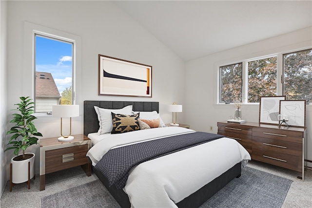 bedroom featuring multiple windows, light carpet, and lofted ceiling