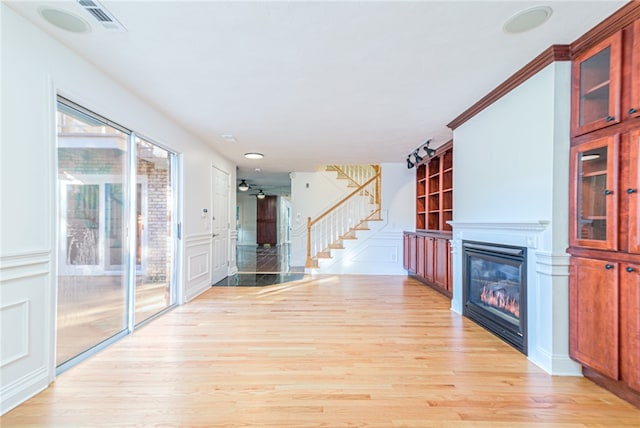 unfurnished living room with light hardwood / wood-style flooring and ceiling fan