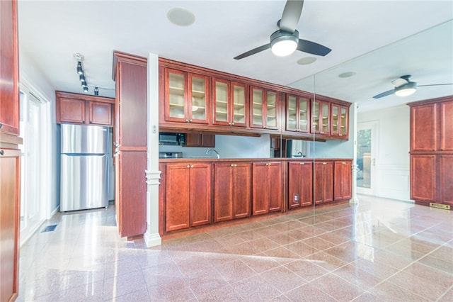 kitchen featuring stainless steel fridge, ornate columns, rail lighting, and ceiling fan