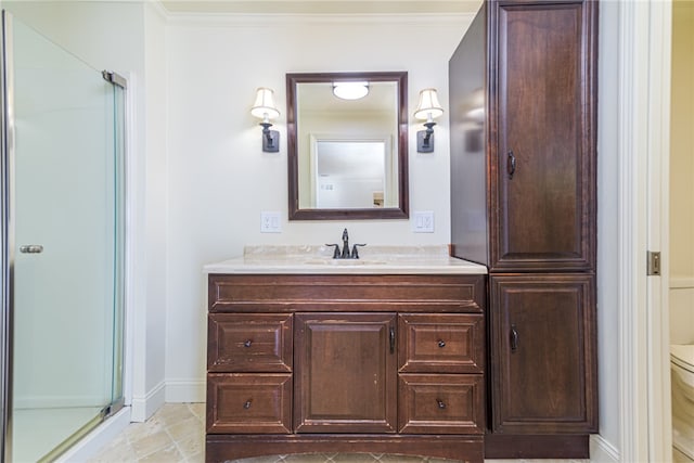 bathroom with a shower with door, toilet, crown molding, and vanity