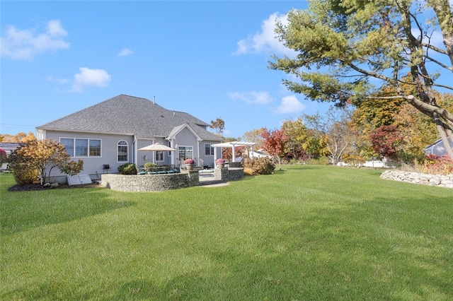 back of house featuring a lawn and a patio