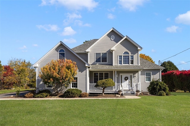 front facade with a porch and a front lawn