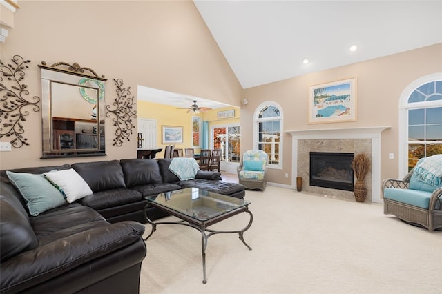 living room featuring ceiling fan, light carpet, and high vaulted ceiling