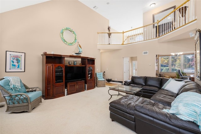 carpeted living room featuring high vaulted ceiling and a notable chandelier