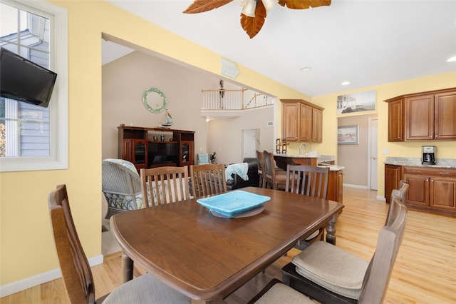 dining area with light hardwood / wood-style flooring and ceiling fan