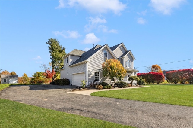 view of front of property with a garage and a front yard