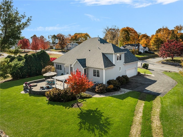 exterior space with a garage and a lawn