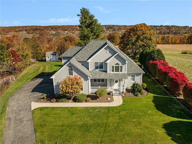 view of front of property with a porch and a front yard