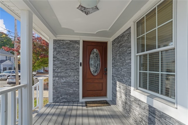 view of exterior entry featuring covered porch