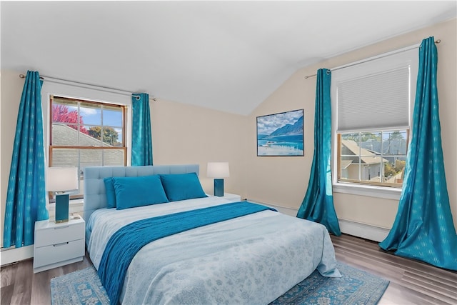 bedroom with baseboard heating, lofted ceiling, hardwood / wood-style floors, and multiple windows