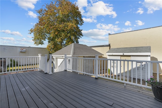 wooden deck featuring a garage