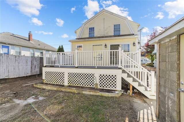 back of property featuring a wooden deck