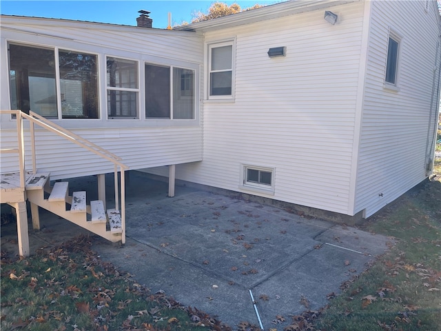 view of property exterior with a patio area