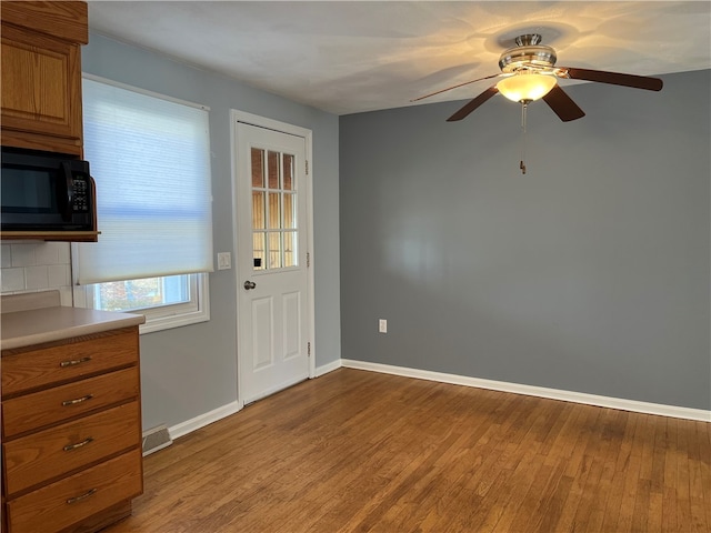 interior space with ceiling fan and light hardwood / wood-style flooring