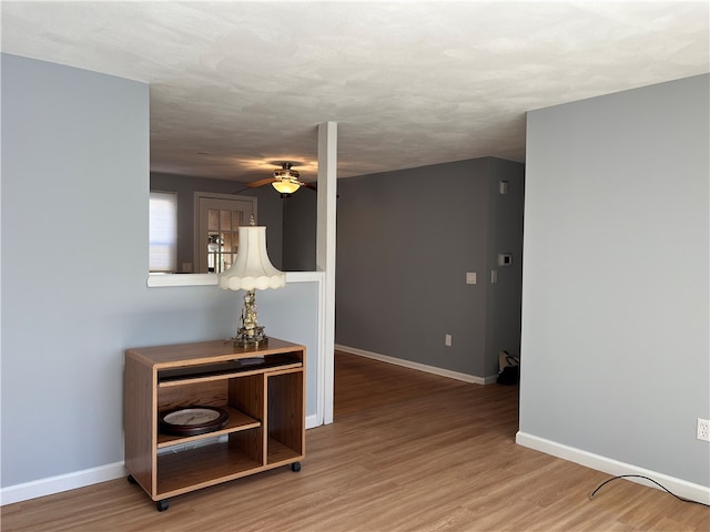 empty room with ceiling fan and wood-type flooring