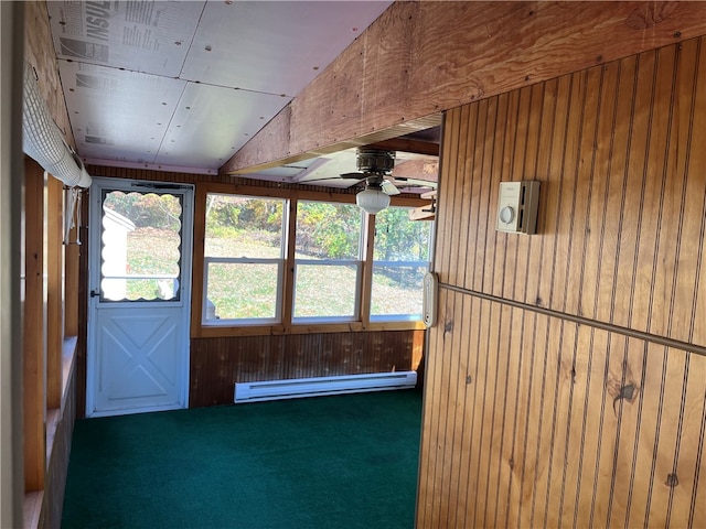 unfurnished sunroom with ceiling fan, vaulted ceiling, and a baseboard radiator