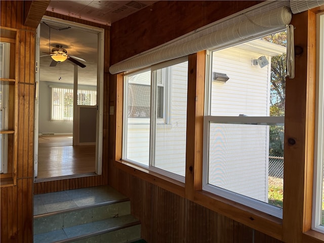 unfurnished sunroom with ceiling fan