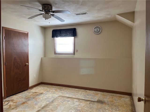 unfurnished room with lofted ceiling, a textured ceiling, and ceiling fan