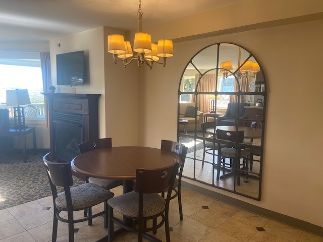 tiled dining area with an inviting chandelier