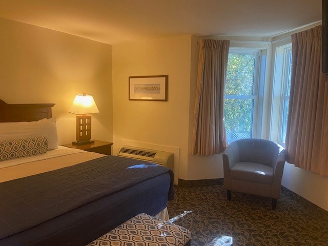 bedroom featuring a wall mounted air conditioner