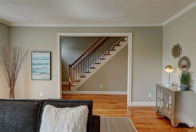 living room with hardwood / wood-style floors and crown molding