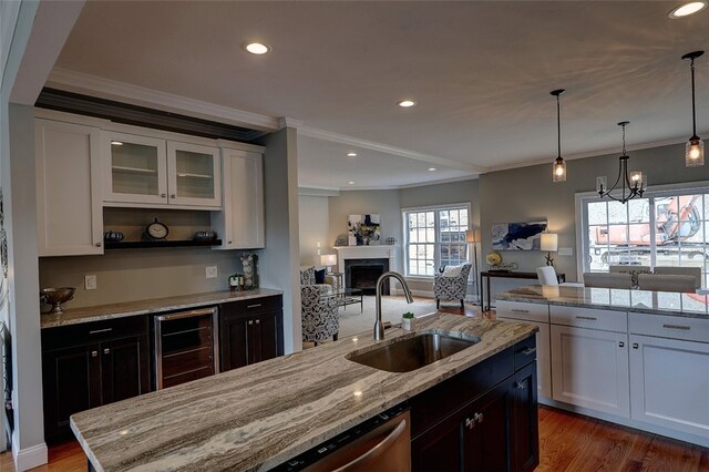 kitchen with crown molding, white cabinets, sink, and dark hardwood / wood-style floors