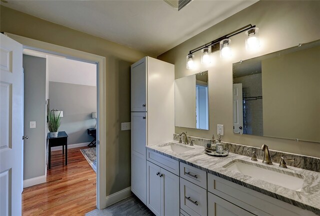 bathroom with vanity and wood-type flooring