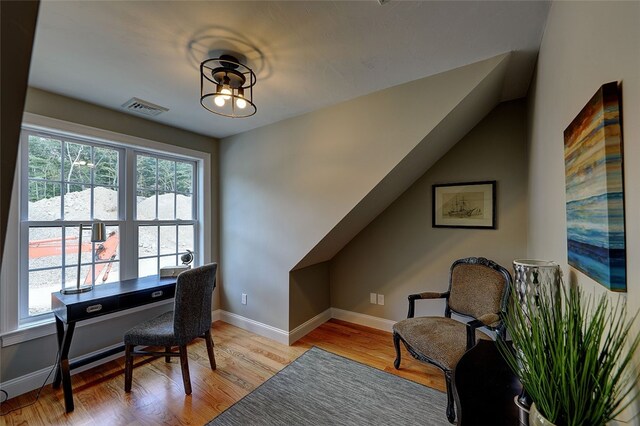 office area with vaulted ceiling and light hardwood / wood-style flooring