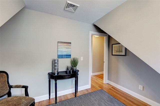 living area with light hardwood / wood-style flooring and lofted ceiling