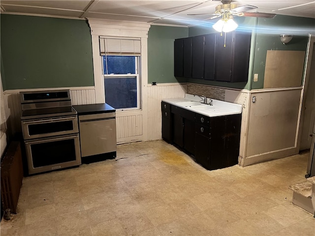 kitchen with ceiling fan, sink, and double oven range