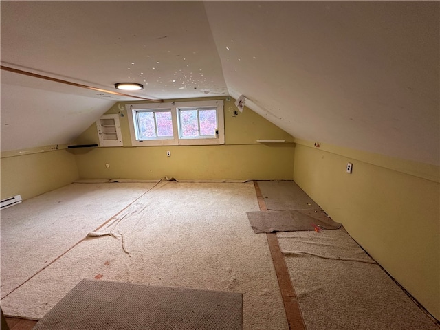 additional living space with carpet and vaulted ceiling