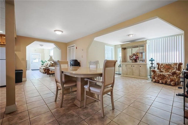 dining area with light tile patterned floors