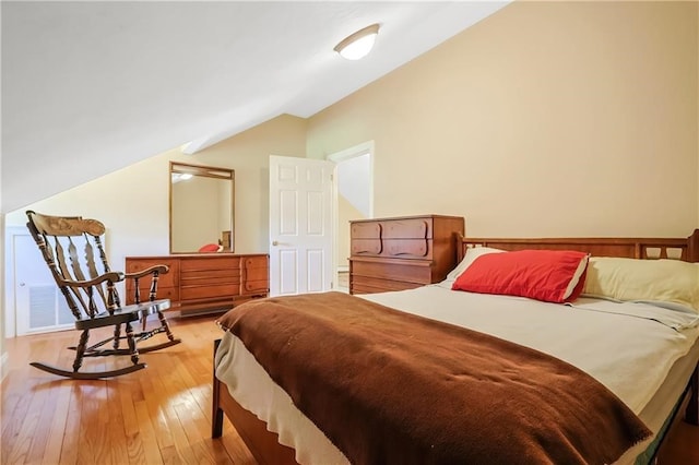 bedroom featuring vaulted ceiling and light hardwood / wood-style flooring