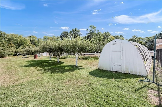 view of yard with a storage shed and a rural view