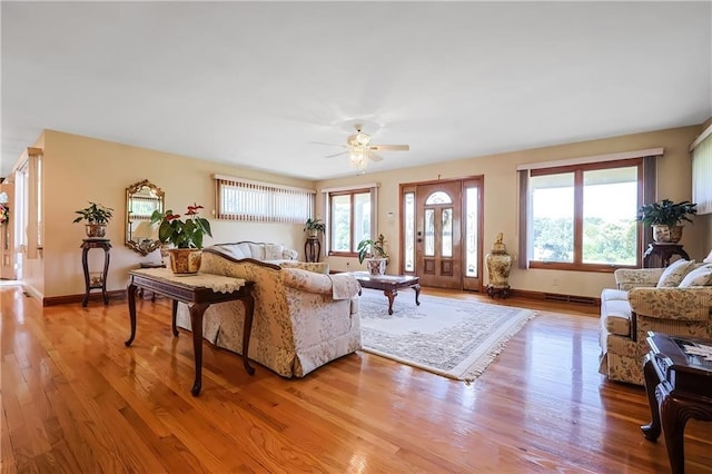 living room featuring light hardwood / wood-style flooring and ceiling fan