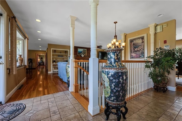 corridor featuring hardwood / wood-style floors and a notable chandelier