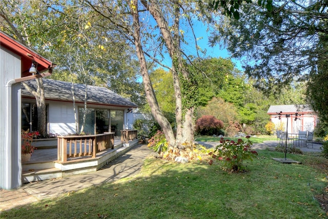 view of yard featuring a wooden deck