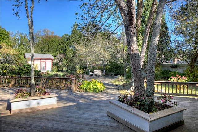 wooden deck featuring a storage unit