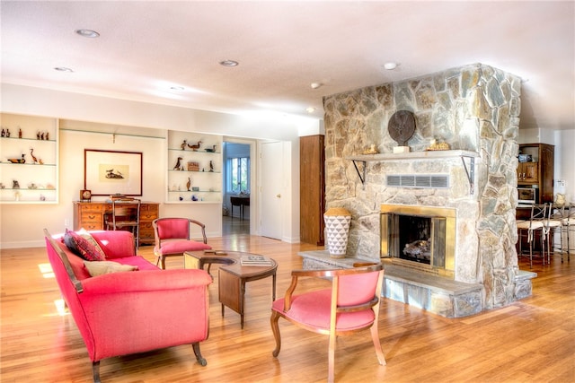 living room with a fireplace and hardwood / wood-style floors