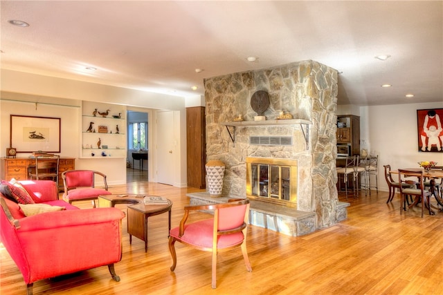 living room featuring a fireplace and wood-type flooring