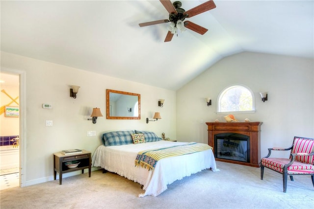 carpeted bedroom with ceiling fan and vaulted ceiling