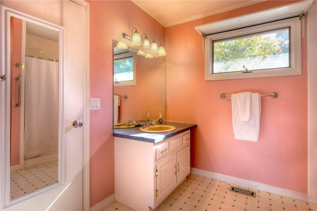 bathroom with curtained shower, vanity, and crown molding