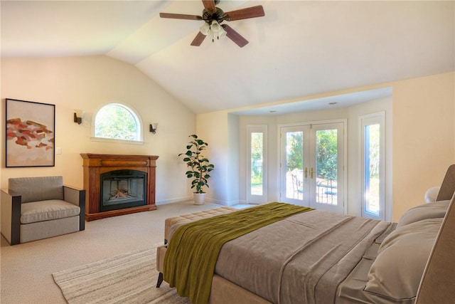 carpeted bedroom featuring ceiling fan, french doors, multiple windows, and lofted ceiling