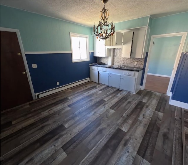 kitchen featuring a baseboard radiator, dark hardwood / wood-style flooring, backsplash, decorative light fixtures, and white cabinets