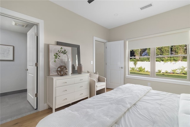 bedroom with light hardwood / wood-style flooring and ceiling fan