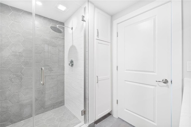 bathroom featuring a shower with shower door