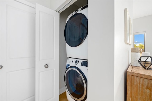 laundry area with stacked washer and dryer