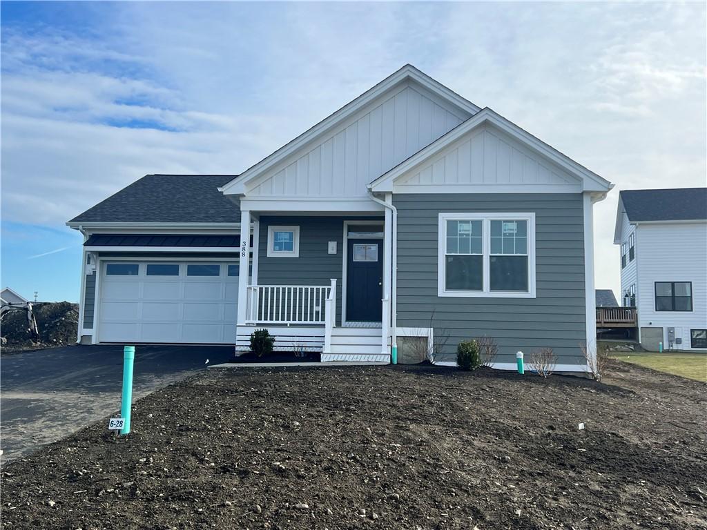 view of front of property featuring a porch and a garage